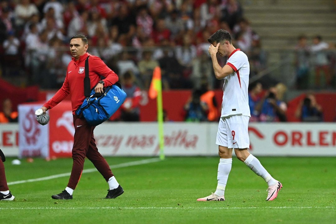 El delantero Robert Lewandowski (d) se retira lesionado durante el amistos que han jugado Polonia y Turquía en Varsovia,